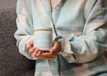 hands holding a chill babe candle co 8 oz spa day candle 